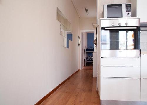 a kitchen with a microwave on top of a refrigerator at Casa al Mare WiFi Ac in Chioggia