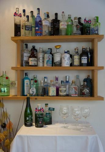 a table with glasses and bottles of alcohol on shelves at Hotel Mondschein in Sesto