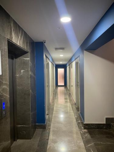 a hallway with blue walls and a hallway with doors at Studio Lego Airport Hotel in Antalya