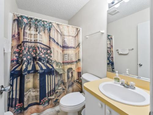 a bathroom with a toilet and a shower curtain at 2 Bedroom 2 Bath Patio Villa in The Villages