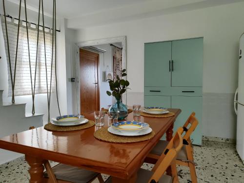 a dining room with a wooden table and chairs at La Huerta del Parral in Soportújar