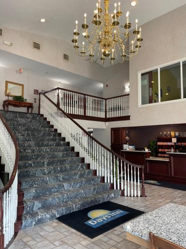 a large lobby with a staircase with a chandelier at Days Inn by Wyndham Lisbon in Lisbon
