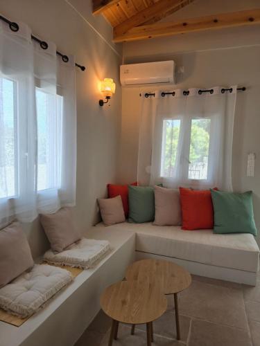 a living room with a couch and two windows at Vrachati Loft in Vrahati