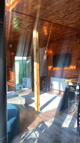 a room with a wooden ceiling and a table at Ayder Villas in Çamlıhemşin