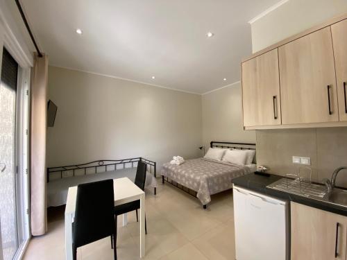 a kitchen and a bedroom with a bed and a table at Catherine's Studios Sivota in Syvota