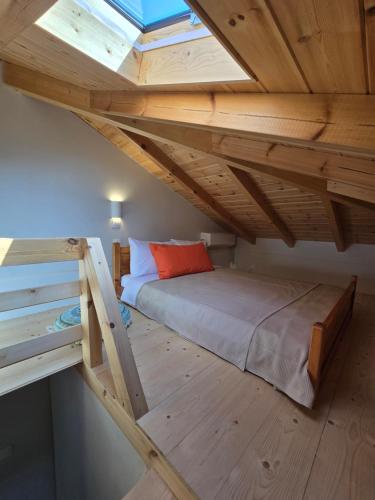 a loft bed in a room with a window at Vrachati Loft in Vrahati