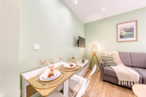 un salon avec une table et un canapé dans l'établissement Casa Verde - near RER B Bagneux, à Bagneux