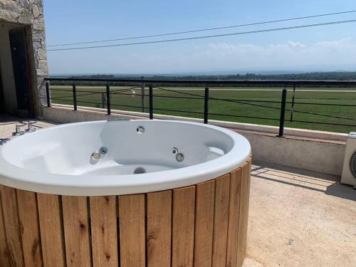 a bath tub sitting on a balcony with a view at DINASTIE COUNTRY APART in Villa Rumipal
