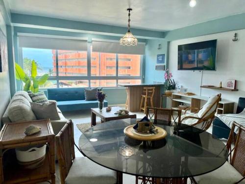a living room with a glass table and a couch at Beach apartment in La Mar Suites, Tucacas Venezuela in Tucacas