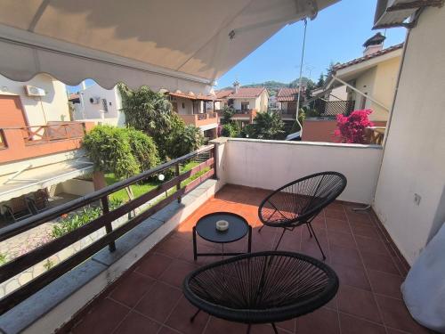 a balcony with two chairs and a table at Perfect House in Pefkochori