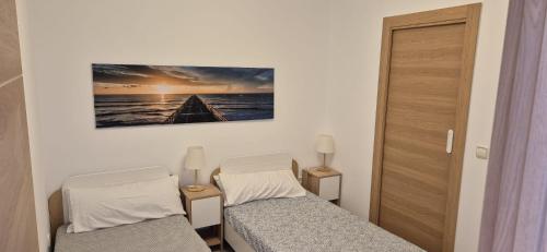a small room with two beds and a door at Vinaros Beach in Vinarós