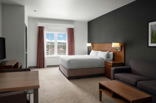 a hotel room with a bed and a couch at Residence Inn by Marriott Breckenridge in Breckenridge