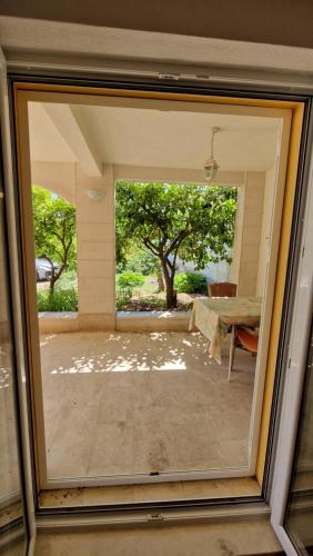 a window view of a patio with a tree at Dijana in Makarska