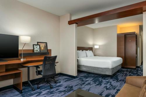 a hotel room with a bed and a desk with a computer at Fairfield Inn & Suites by Marriott Twin Falls in Twin Falls