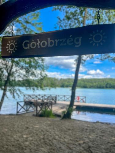 a sign that says googrape hanging from a swing at Ostoja Bukowo 12,2 chata u szôłtësa in Borowy Młyn