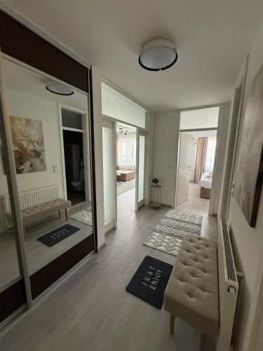 a living room with a mirror and a chair at Aurum Modern in Sarajevo