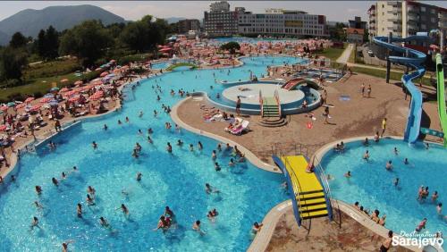 a group of people in a pool at a water park at Aurum Modern in Sarajevo