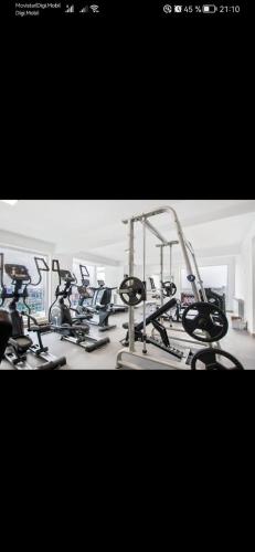a gym with several cardio bikes and tread machines at Meraki Resort & Spa Isabellae Home in Mamaia Nord