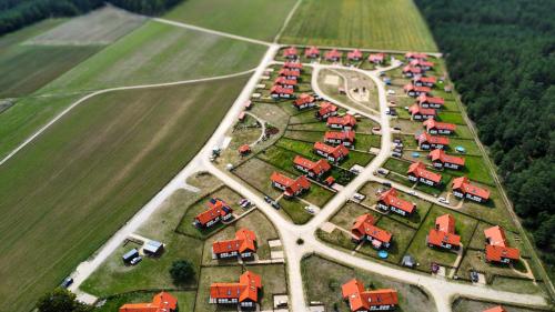 an aerial view of a farm with cars and trucks at Ostoja Bukowo 12,2 chata u szôłtësa in Borowy Młyn
