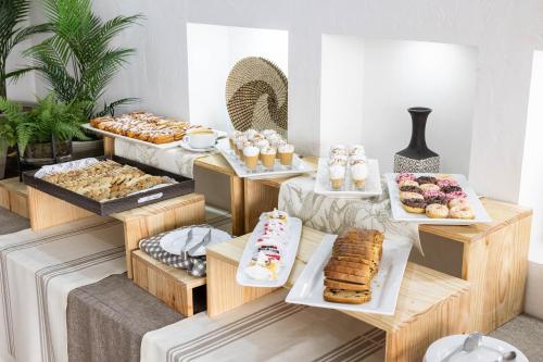 a buffet with many different types of pastries and desserts at Hotel Gran Palace in Santiago