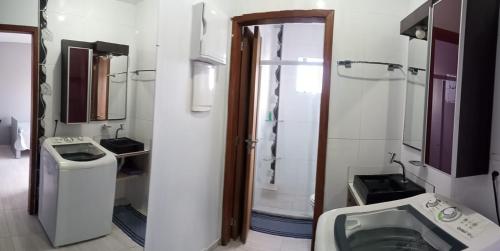 a bathroom with a toilet and a sink and a shower at Studio em São José SC in São José