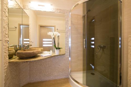 a bathroom with a glass shower and a sink at Restauracja Joanna in Kluczbork