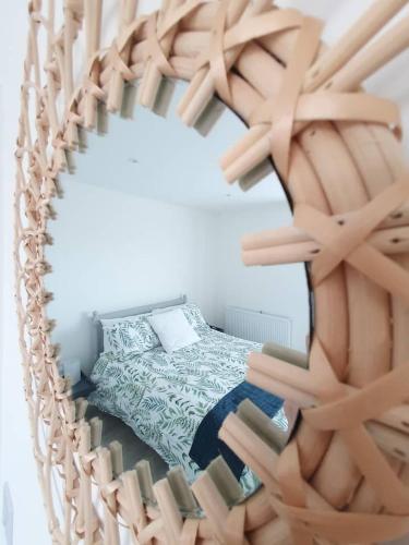 a bedroom with a bed and a mirror at Sea Breeze - Sea Scape View in Keiss