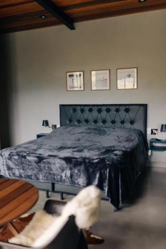 a bedroom with a bed with a blue comforter at Villa Mantiqueira SFX - Cabanas in São José dos Campos