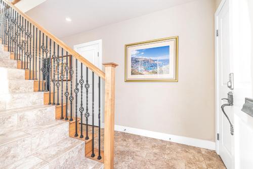 a staircase in a home with a picture on the wall at Charming 2Br Condo W Ac Steps To Beach & Balboa Pier By Beachview Rentals in Newport Beach