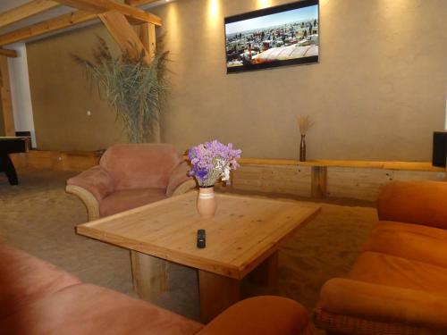 a living room with a table with flowers on it at Wochenend-Auszeit in Möckern