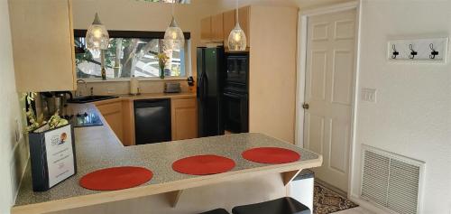a kitchen with a table with red plates on it at Sunset Cove in Clermont