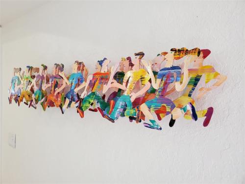 a painting of a group of people on a wall at Finding Balance at Swiss in Clermont