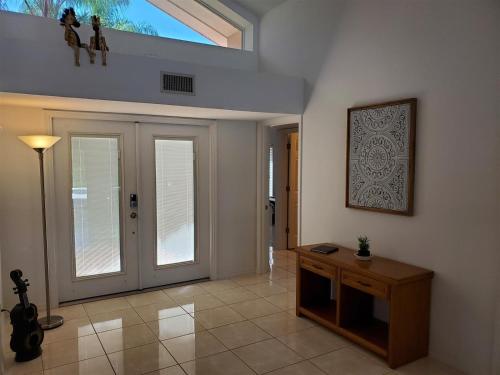 a living room with a sliding glass door and a table at Lakes View at Swiss in Clermont