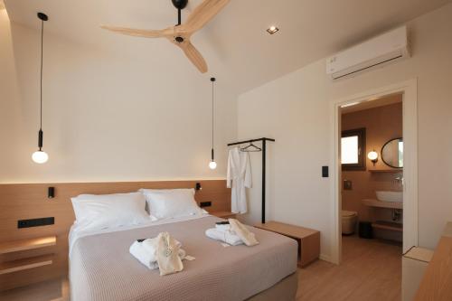 a bedroom with a bed with towels on it at Anapnoe ikies Corfu Adults Friendly in Sfakerá