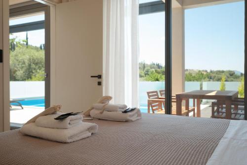 a bedroom with a bed with towels on it at Anapnoe ikies Corfu Adults Friendly in Sfakerá