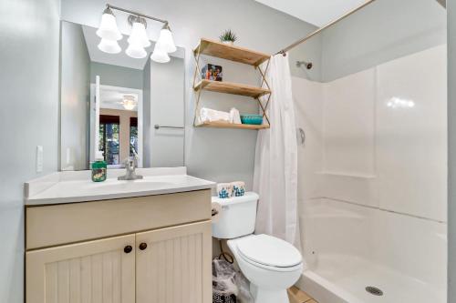 a bathroom with a toilet and a sink and a shower at Soundfront Stay Beach Pools & More at The Spa in Hilton Head Island