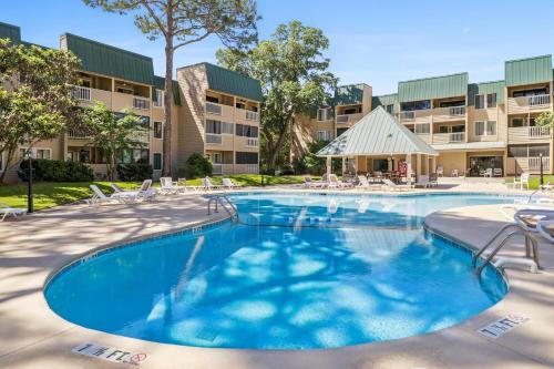 an image of a swimming pool at a apartment complex at Soundfront Stay Beach Pools & More at The Spa in Hilton Head Island