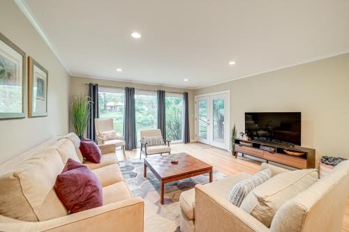 a living room with two couches and a television at 6 Mi to Dtwn Waterfront Home in Tulsa! in Tulsa