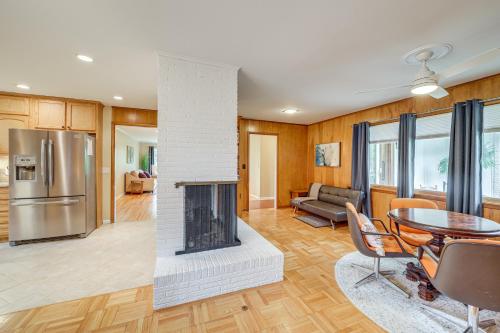 a living room with a fireplace and a table at 6 Mi to Dtwn Waterfront Home in Tulsa! in Tulsa