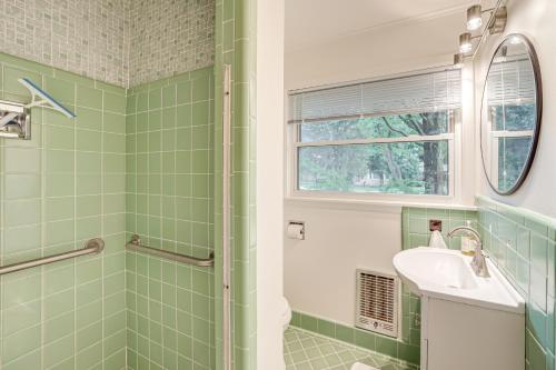 a green bathroom with a sink and a shower at 6 Mi to Dtwn Waterfront Home in Tulsa! in Tulsa
