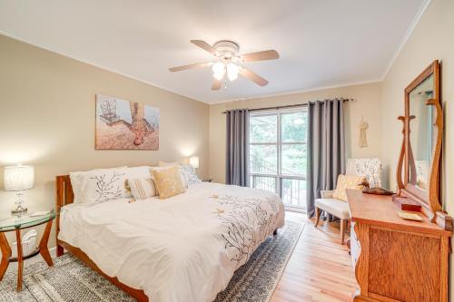 a bedroom with a bed and a ceiling fan at 6 Mi to Dtwn Waterfront Home in Tulsa! in Tulsa