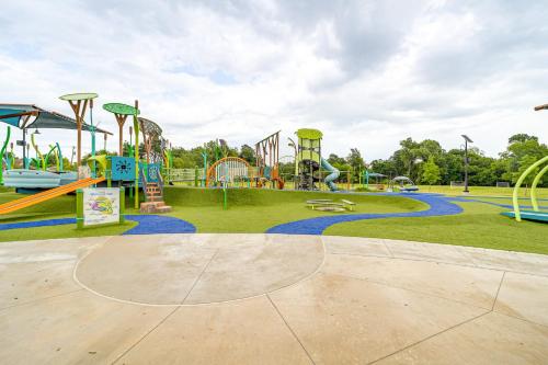 a park with a playground with a roller coaster at 6 Mi to Dtwn Waterfront Home in Tulsa! in Tulsa