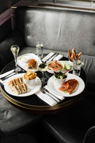 a round table with plates of food on it at The Shelbourne, Autograph Collection in Dublin