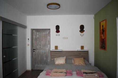 a bedroom with a bed with two towels on it at Villa Pannonia in Pannonhalma