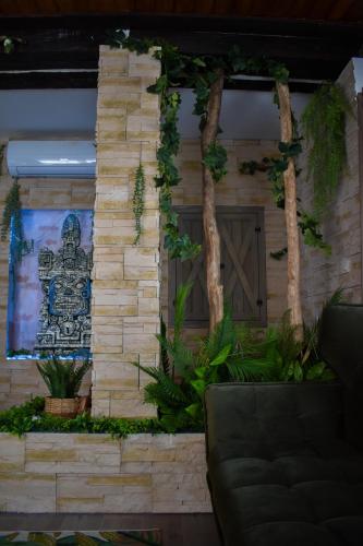 a building with a wooden door with plants on it at Villa Pannonia in Pannonhalma