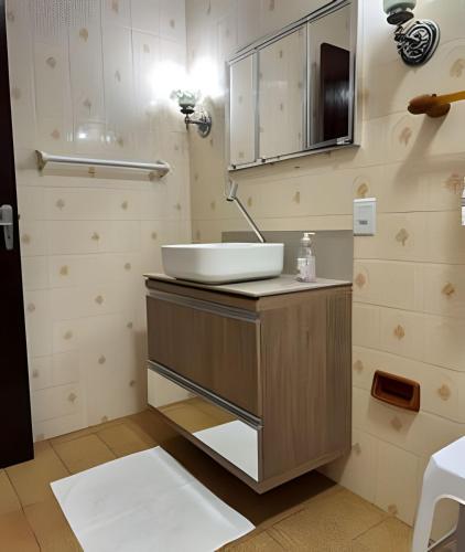 a bathroom with a sink and a mirror at Large apartment in the center in Pomerode