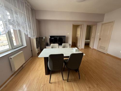 a dining room with a white table and chairs at Central apt II in Sunny town in Ulaanbaatar