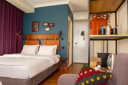 a bedroom with a large bed and a blue wall at The Abies in Canakkale