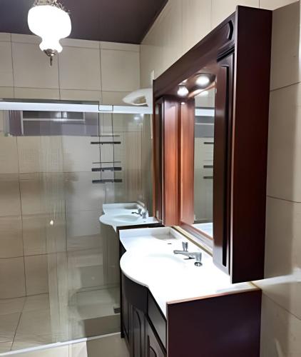 a bathroom with two sinks and a mirror at Apartment well located in the center in Pomerode