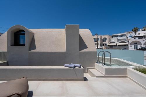a building next to a swimming pool with a pool at White Orchid Boutique Apartments in Vóthon